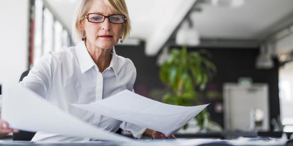 Woman reading documents on can an irrevocable trust be changed